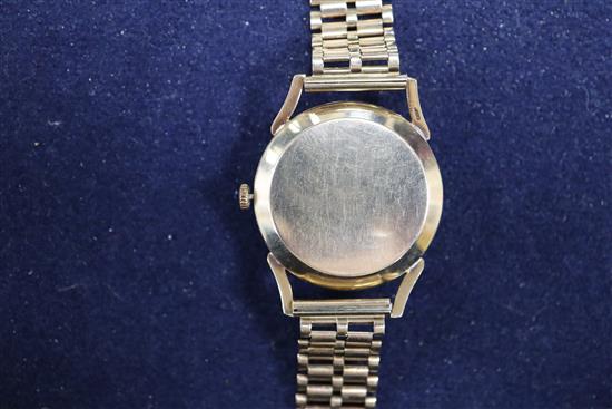 A gentlemans 9ct gold Rolex precision wristwatch, with gilt Arabic numerals, gold handles and blued steel centre